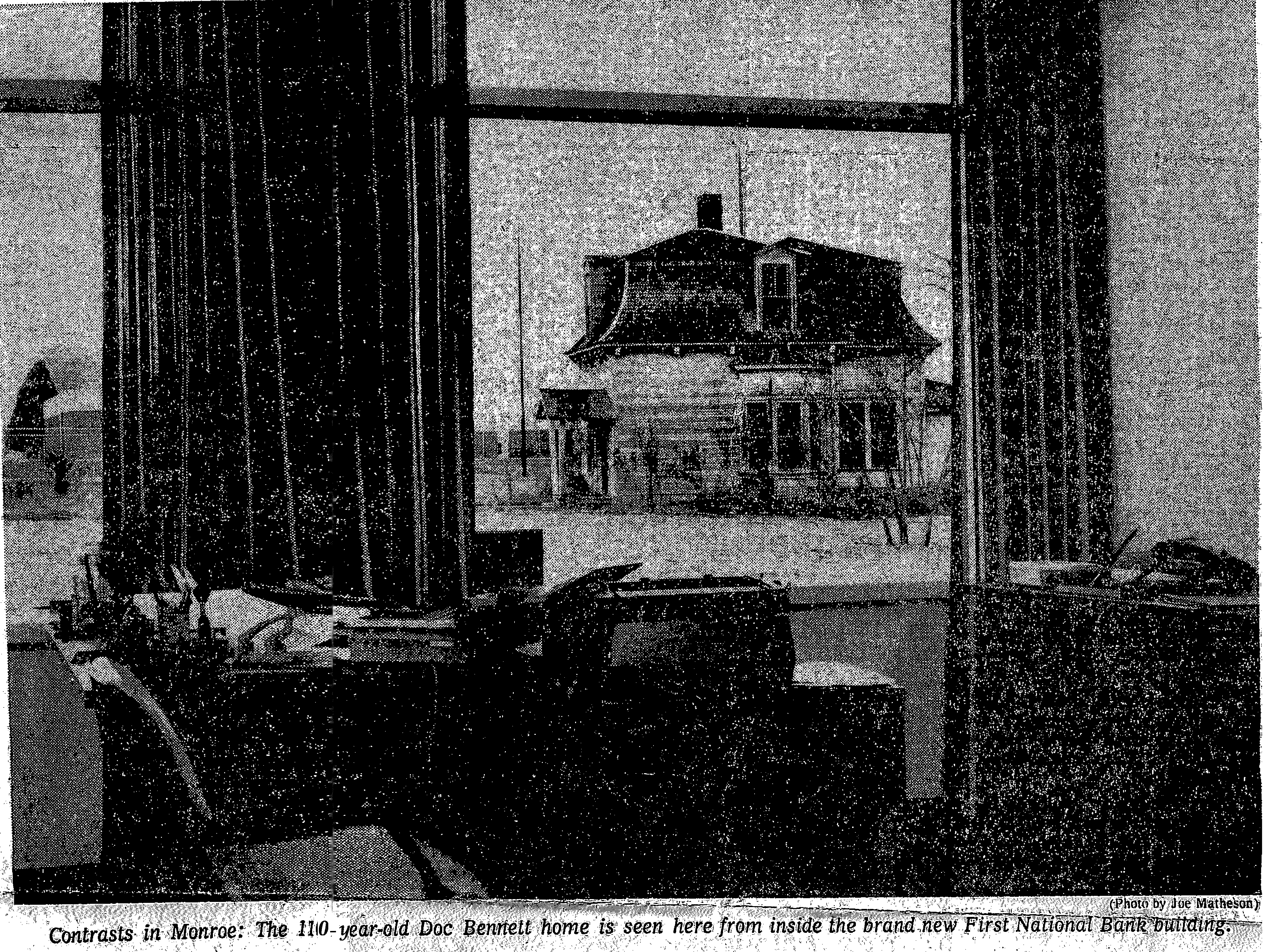 Newspaper photo of the Doc Bennett home in Monroe seen through a bank window